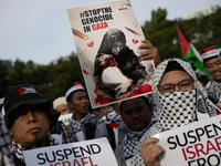 Indonesian people shout slogans and hold placards during a pro-Palestinian demonstration in front of the US Embassy in Jakarta, Indonesia, o...