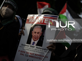 An Indonesian woman attends a rally during a pro-Palestinian demonstration in front of the US Embassy in Jakarta, Indonesia, on November 29,...