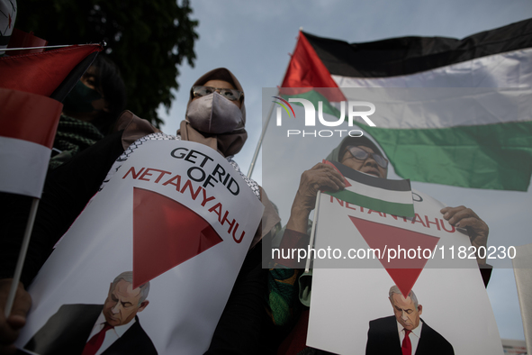 An Indonesian woman attends a rally during a pro-Palestinian demonstration in front of the US Embassy in Jakarta, Indonesia, on November 29,...