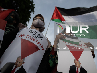 An Indonesian woman attends a rally during a pro-Palestinian demonstration in front of the US Embassy in Jakarta, Indonesia, on November 29,...