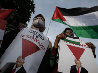 An Indonesian woman attends a rally during a pro-Palestinian demonstration in front of the US Embassy in Jakarta, Indonesia, on November 29,...