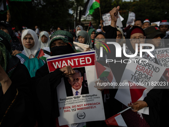 Indonesian people shout slogans and hold placards during a pro-Palestinian demonstration in front of the US Embassy in Jakarta, Indonesia, o...