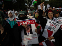 Indonesian people shout slogans and hold placards during a pro-Palestinian demonstration in front of the US Embassy in Jakarta, Indonesia, o...