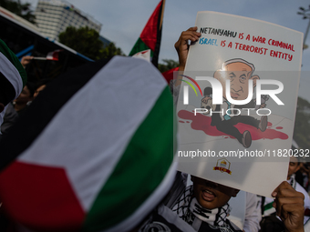 Indonesian people shout slogans and hold placards during a pro-Palestinian demonstration in front of the US Embassy in Jakarta, Indonesia, o...