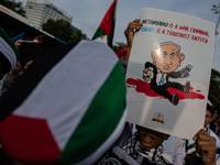 Indonesian people shout slogans and hold placards during a pro-Palestinian demonstration in front of the US Embassy in Jakarta, Indonesia, o...