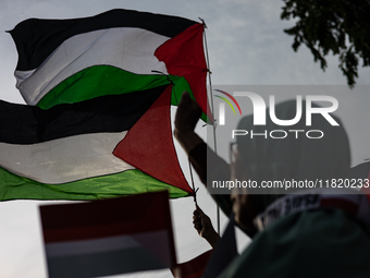 Indonesian people shout slogans and hold placards during a pro-Palestinian demonstration in front of the US Embassy in Jakarta, Indonesia, o...