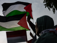 Indonesian people shout slogans and hold placards during a pro-Palestinian demonstration in front of the US Embassy in Jakarta, Indonesia, o...