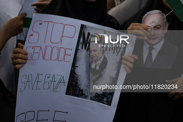 Indonesian people shout slogans and hold placards during a pro-Palestinian demonstration in front of the US Embassy in Jakarta, Indonesia, o...