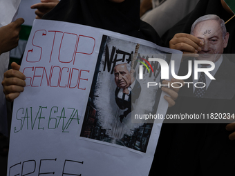 Indonesian people shout slogans and hold placards during a pro-Palestinian demonstration in front of the US Embassy in Jakarta, Indonesia, o...