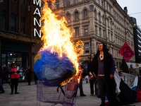 Activists from Elokapina, or Extinction Rebellion Finland, protest against Black Friday in Helsinki, Finland, on November 29, 2024. The acti...