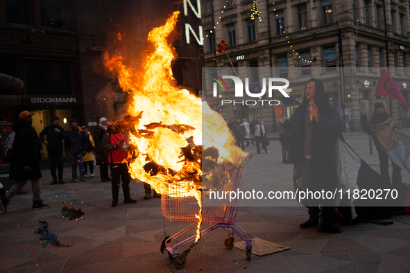 Activists from Elokapina, or Extinction Rebellion Finland, protest against Black Friday in Helsinki, Finland, on November 29, 2024. The acti...