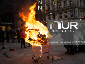 Activists from Elokapina, or Extinction Rebellion Finland, protest against Black Friday in Helsinki, Finland, on November 29, 2024. The acti...