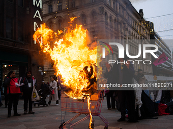 Activists from Elokapina, or Extinction Rebellion Finland, protest against Black Friday in Helsinki, Finland, on November 29, 2024. The acti...