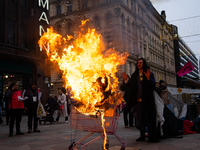 Activists from Elokapina, or Extinction Rebellion Finland, protest against Black Friday in Helsinki, Finland, on November 29, 2024. The acti...