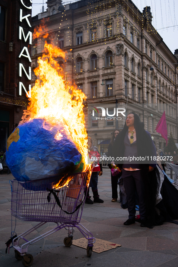 Activists from Elokapina, or Extinction Rebellion Finland, protest against Black Friday in Helsinki, Finland, on November 29, 2024. The acti...