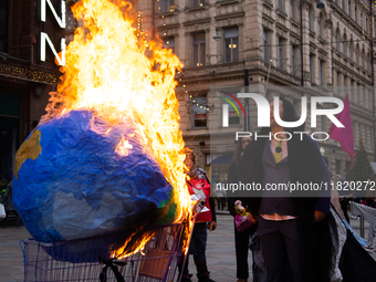 Activists from Elokapina, or Extinction Rebellion Finland, protest against Black Friday in Helsinki, Finland, on November 29, 2024. The acti...