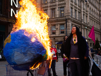 Activists from Elokapina, or Extinction Rebellion Finland, protest against Black Friday in Helsinki, Finland, on November 29, 2024. The acti...