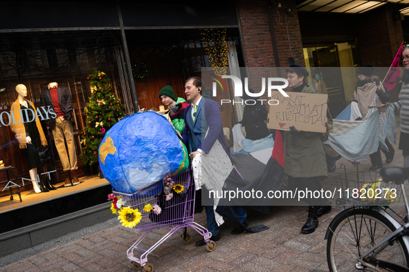 Activists from Elokapina, or Extinction Rebellion Finland, protest against Black Friday in Helsinki, Finland, on November 29, 2024. The acti...