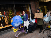 Activists from Elokapina, or Extinction Rebellion Finland, protest against Black Friday in Helsinki, Finland, on November 29, 2024. The acti...