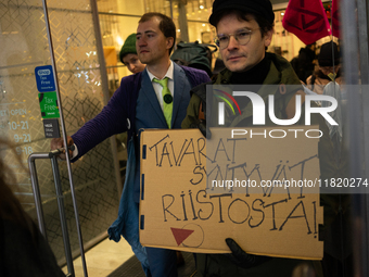 Activists from Elokapina, or Extinction Rebellion Finland, protest against Black Friday in Helsinki, Finland, on November 29, 2024. The acti...