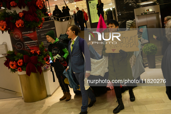 Activists from Elokapina, or Extinction Rebellion Finland, protest against Black Friday in Helsinki, Finland, on November 29, 2024. The acti...