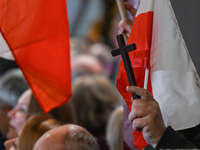 KRAKOW, POLAND - NOVEMBER 24:
One of the party supporters holds a Polish flag and a cross at the event where Karol Nawrocki was nominated as...