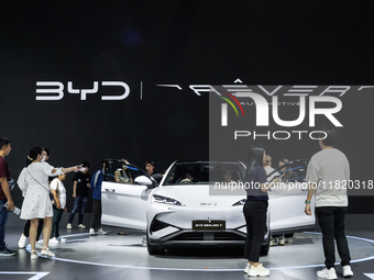 Visitors inspect a BYD SEALION 7 electric car displayed at the Thailand International Motor Expo 2024 at IMPACT exhibition center in Bangkok...