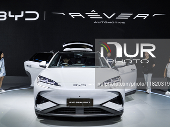 Visitors inspect a BYD SEALION 7 electric car displayed at the Thailand International Motor Expo 2024 at IMPACT exhibition center in Bangkok...