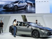 Visitors inspect a Toyota Camry car displayed at the Thailand International Motor Expo 2024 at the IMPACT Exhibition Center in Bangkok, Thai...