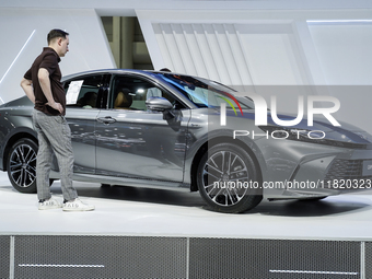 Visitors inspect a Toyota Camry car displayed at the Thailand International Motor Expo 2024 at the IMPACT Exhibition Center in Bangkok, Thai...