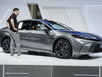 Visitors inspect a Toyota Camry car displayed at the Thailand International Motor Expo 2024 at the IMPACT Exhibition Center in Bangkok, Thai...