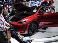 Visitors inspect a TESLA electric car displayed at the Thailand International Motor Expo 2024 at the IMPACT exhibition center in Bangkok, Th...