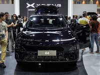 Visitors inspect an XPENG G6 electric car displayed at the Thailand International Motor Expo 2024 at the IMPACT exhibition center in Bangkok...