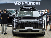 Visitors inspect a Hyundai Palisade electric car displayed at the Thailand International Motor Expo 2024 at the IMPACT Exhibition Center in...