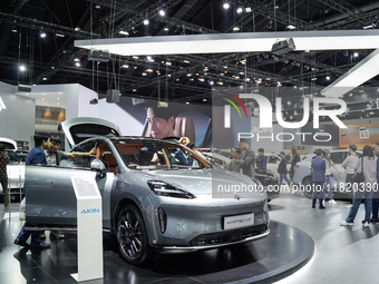 Visitors inspect an AION HYPTEC HT electric car displayed at the Thailand International Motor Expo 2024 at the IMPACT exhibition center in B...