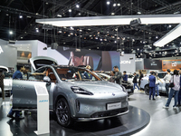 Visitors inspect an AION HYPTEC HT electric car displayed at the Thailand International Motor Expo 2024 at the IMPACT exhibition center in B...