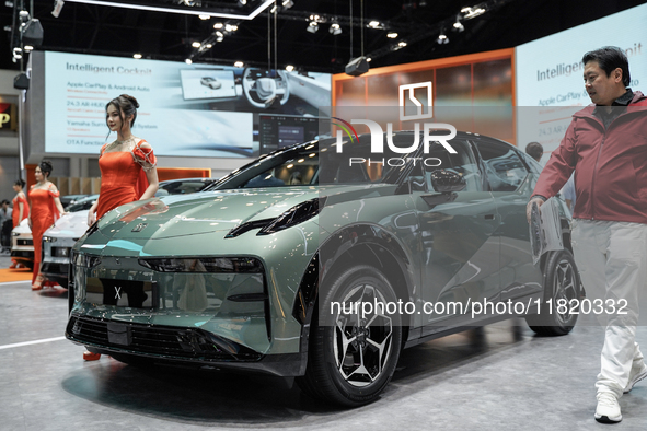 A model stands next to an electric ZEEKR X at the Thailand International Motor Expo 2024 at the IMPACT exhibition center in Bangkok, Thailan...