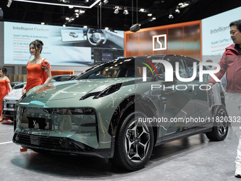 A model stands next to an electric ZEEKR X at the Thailand International Motor Expo 2024 at the IMPACT exhibition center in Bangkok, Thailan...