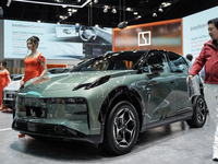 A model stands next to an electric ZEEKR X at the Thailand International Motor Expo 2024 at the IMPACT exhibition center in Bangkok, Thailan...