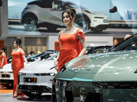 A model stands next to an electric ZEEKR X at the Thailand International Motor Expo 2024 at the IMPACT exhibition center in Bangkok, Thailan...