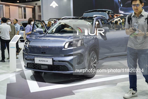 Visitors inspect an AION V electric car displayed at the Thailand International Motor Expo 2024 at the IMPACT exhibition center in Bangkok,...