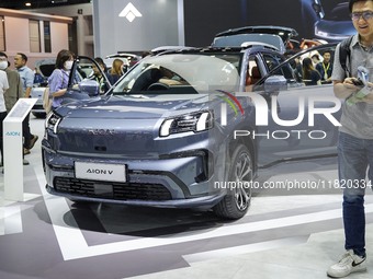 Visitors inspect an AION V electric car displayed at the Thailand International Motor Expo 2024 at the IMPACT exhibition center in Bangkok,...