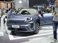 Visitors inspect an AION V electric car displayed at the Thailand International Motor Expo 2024 at the IMPACT exhibition center in Bangkok,...