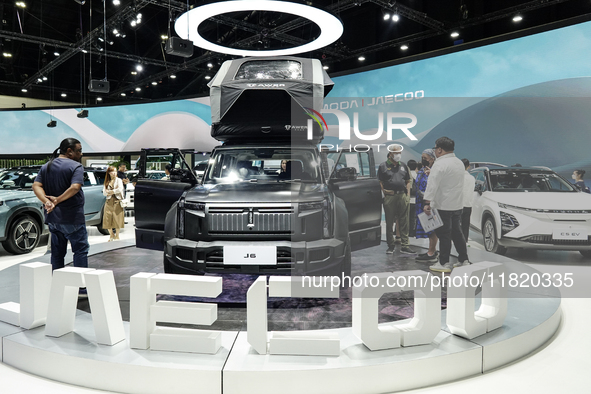 Visitors inspect a JAECOO 6 EV electric car displayed at the Thailand International Motor Expo 2024 at the IMPACT exhibition center in Bangk...