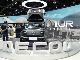 Visitors inspect a JAECOO 6 EV electric car displayed at the Thailand International Motor Expo 2024 at the IMPACT exhibition center in Bangk...