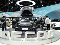 Visitors inspect a JAECOO 6 EV electric car displayed at the Thailand International Motor Expo 2024 at the IMPACT exhibition center in Bangk...