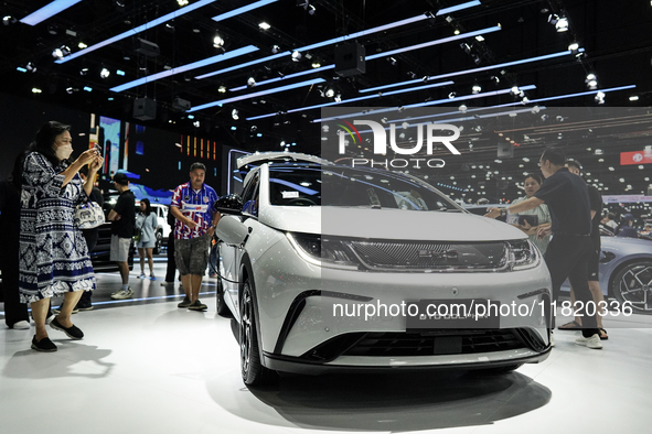 Visitors inspect a BYD DOLPHIN electric car displayed at the Thailand International Motor Expo 2024 at the IMPACT exhibition center in Bangk...