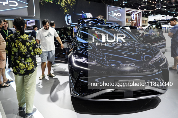 Visitors inspect a BYD SEALION 7 electric car displayed at the Thailand International Motor Expo 2024 at IMPACT exhibition center in Bangkok...