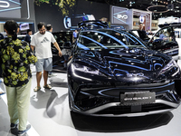 Visitors inspect a BYD SEALION 7 electric car displayed at the Thailand International Motor Expo 2024 at IMPACT exhibition center in Bangkok...