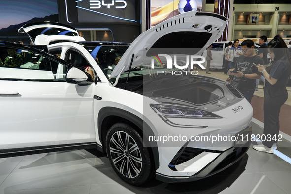 Visitors inspect a BYD SEALION 7 electric car displayed at the Thailand International Motor Expo 2024 at IMPACT exhibition center in Bangkok...